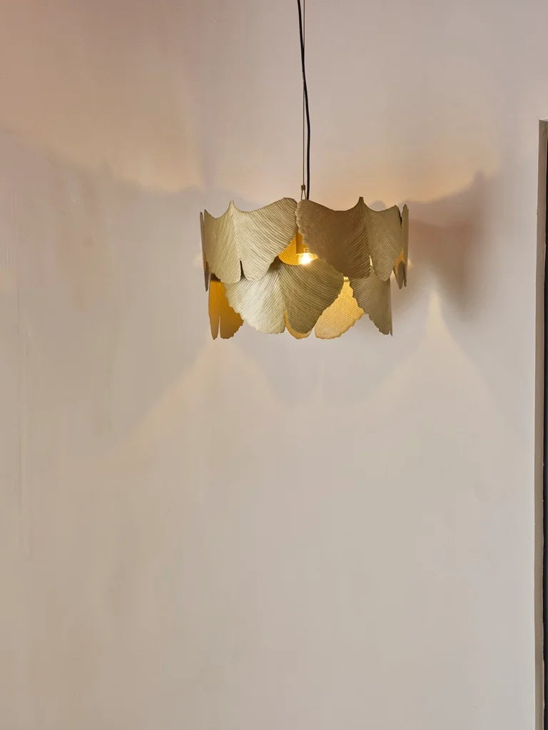 Alternative angle of the brass ginkgo pendant showing the organic texture and ambient glow. Suitable for dining or entryway.