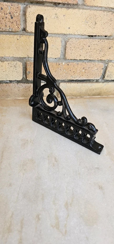 Decorative L-shaped iron bracket robust and artistic design for interior or garden use.