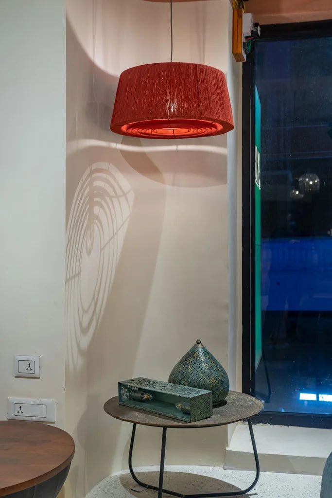 Handcrafted red jute pendant lamp glowing warmly perfect for cozy corners and ambient interiors.