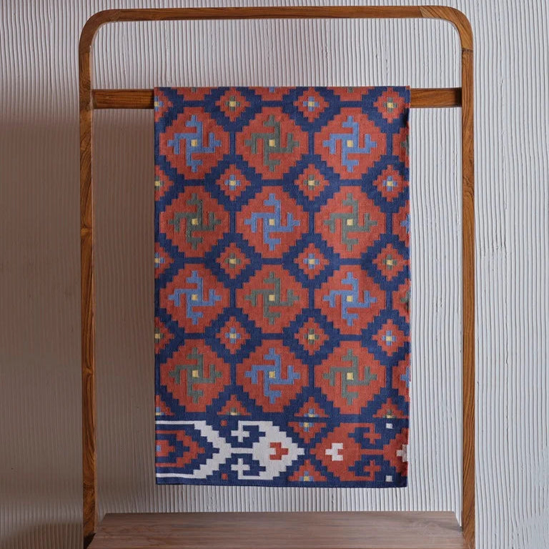 Handcrafted terracotta dhurrie rug ethnic floor decor with geometric tribal design.