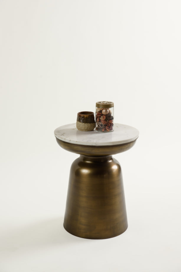 Decorated Aila table with marble top and golden base shown in a warm setting.