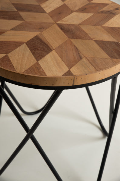 Round wooden top side table with geometric pattern and black iron base.