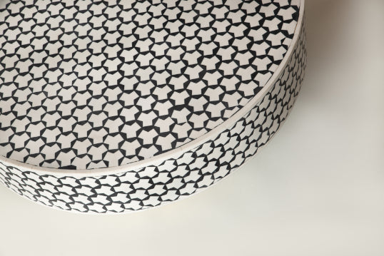 Close-up view of mosaic tiled tabletop with artistic geometric design.