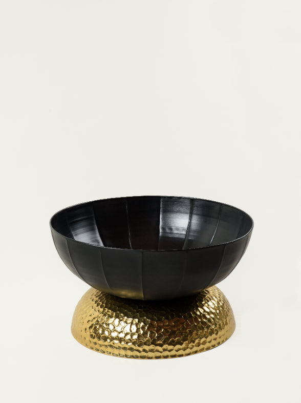 Storage bowl of the Valentina coffee table shown open with glossy black interior and hammered brass foundation – stylish and functional piece by Troika Life.