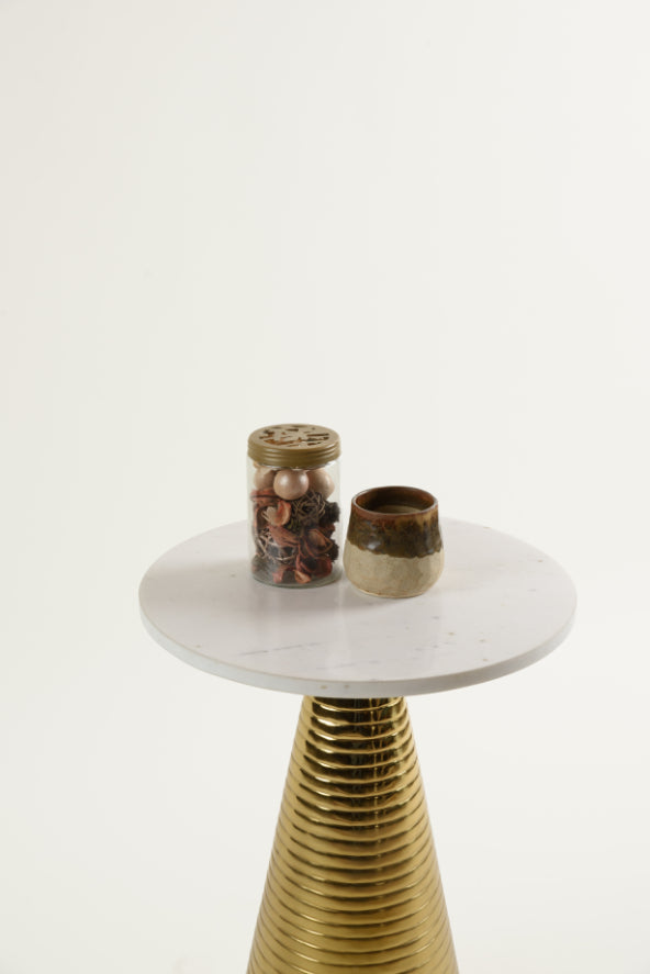 Top view of Yves marble side table showing decorative jar and earthy-toned ceramic cup on sleek surface.