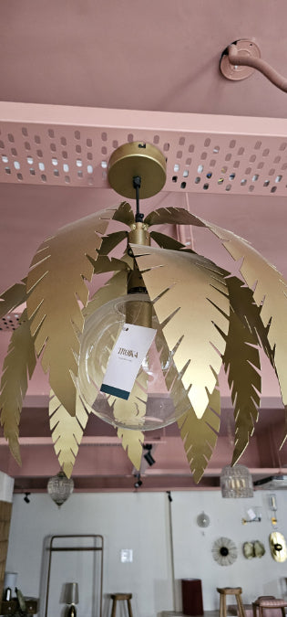 Close-up of Troika Willow Pendant Light showing layered golden leaf accents and a clear glass bulb holder
