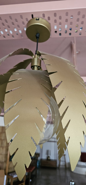 Detailed top view of Willow Pendant Light highlighting brushed gold leaf-like blades and black suspension rod.