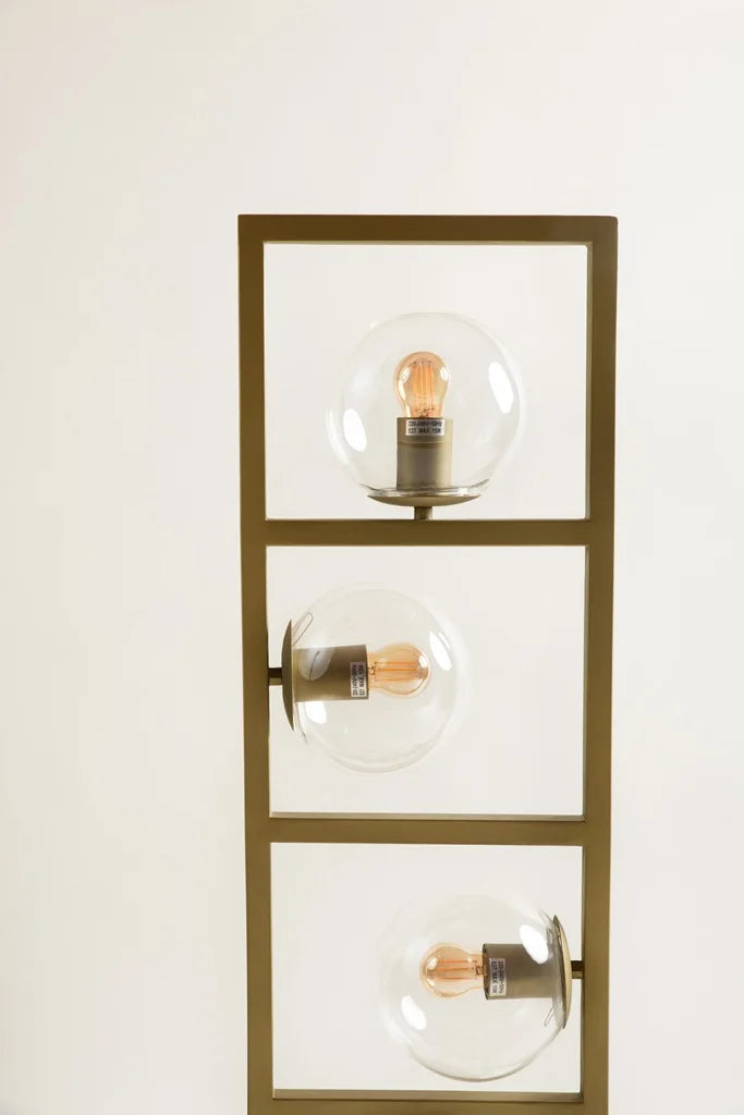 Close-up view of modern designer floor lamp with spherical glass bulbs arranged in a bronze rectangular structure – bold lighting by Troika.
