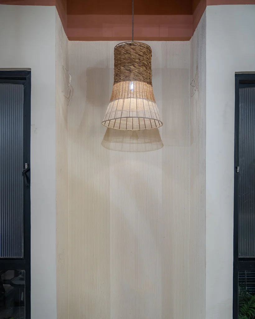 Rustic cane pendant lamp in a cozy wall niche – eco-friendly rattan ceiling light with soft ambient glow.