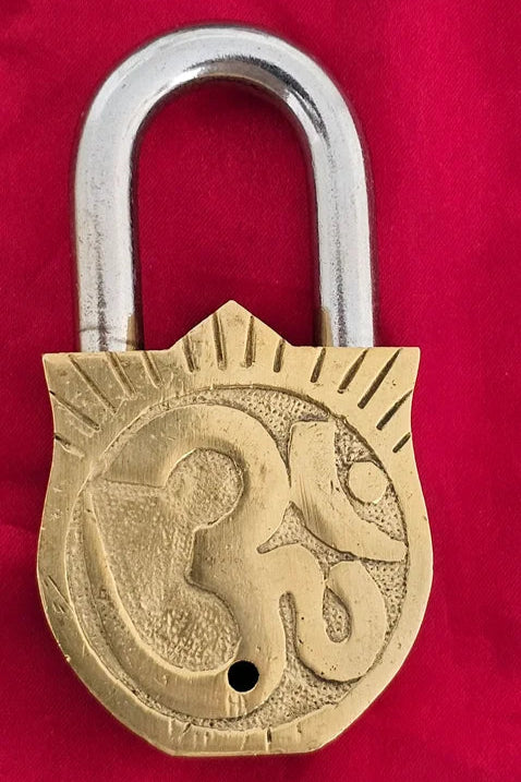 Traditional brass padlock engraved with Om symbol – vintage Indian-style decorative lock with spiritual symbolism.