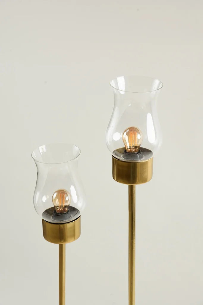 Maya lamp with brass rod and clear glass base stylish floor light with red fabric lampshade.