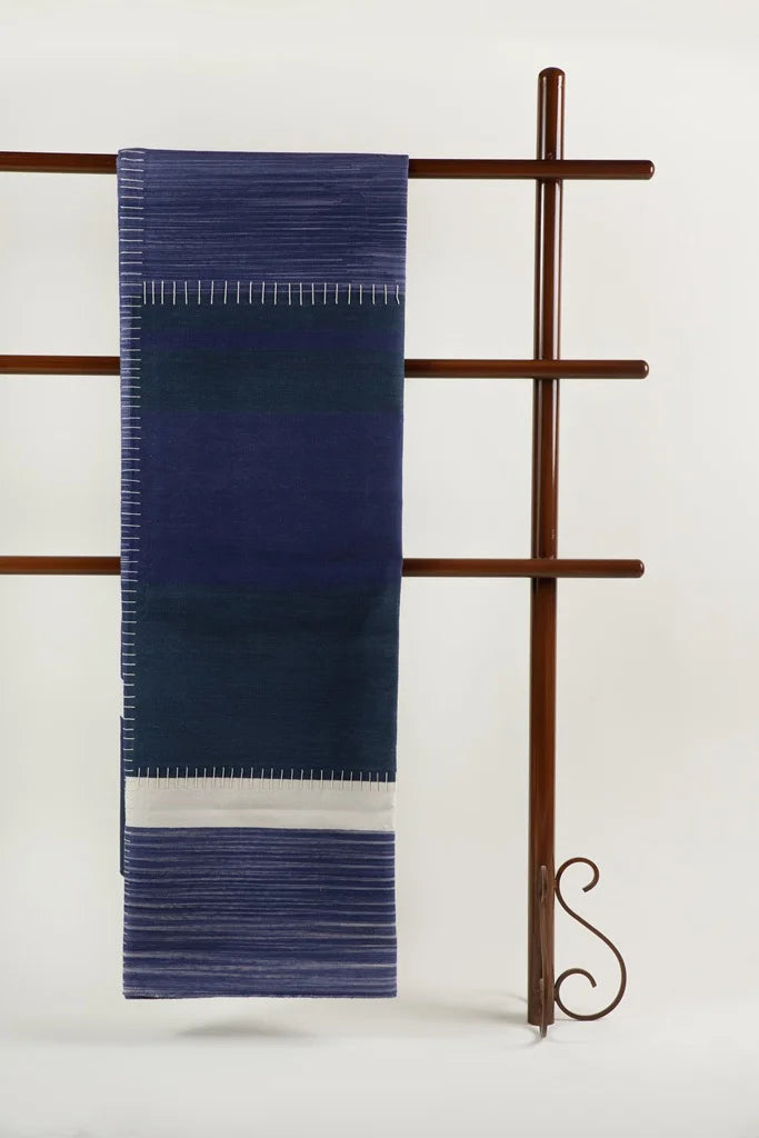 Full view of blue Neel block durrie on wooden ladder stand elegant handcrafted cotton home accessory.