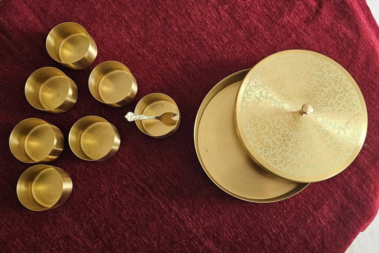 Engraved brass spice box set with lid and spoon handcrafted Indian kitchen storage for masalas.