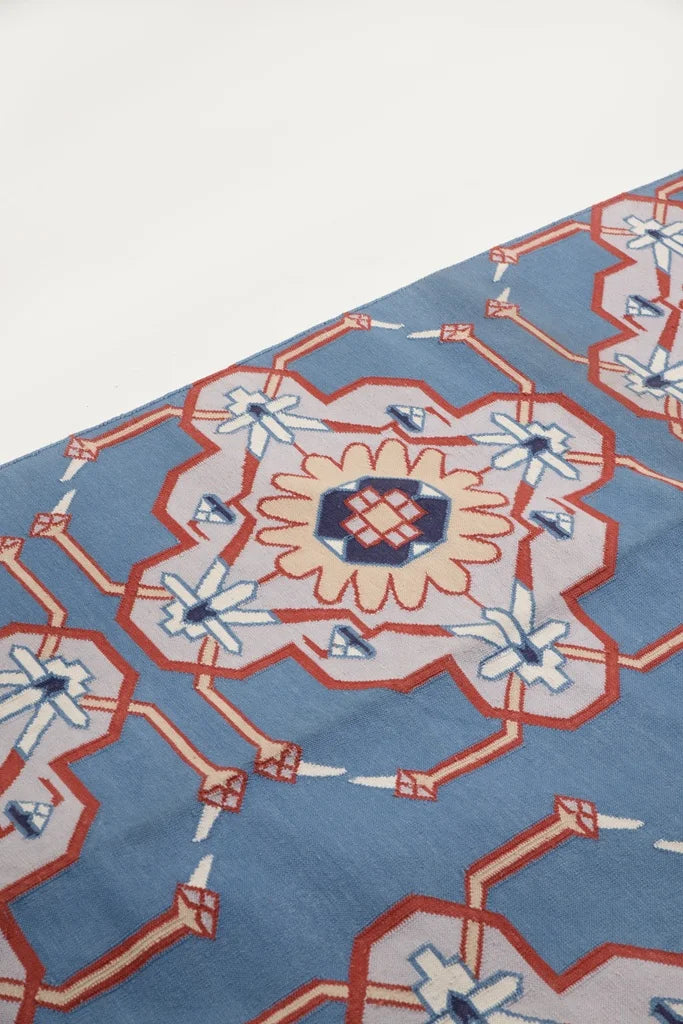 Close-up of Thar Legacy dhurrie pattern highlighting floral motif in center.