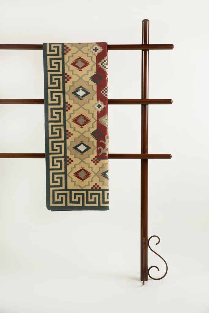Virasat Legacy Durrie draped over brown wooden frame showcasing geometric Indian motifs in beige and red tones