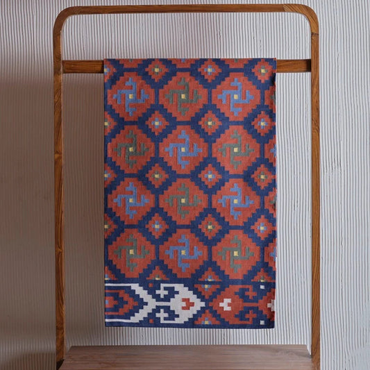 Handcrafted terracotta dhurrie rug ethnic floor decor with geometric tribal design.