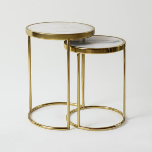 Minimal nesting tables with white marble tops and gold metal legs.