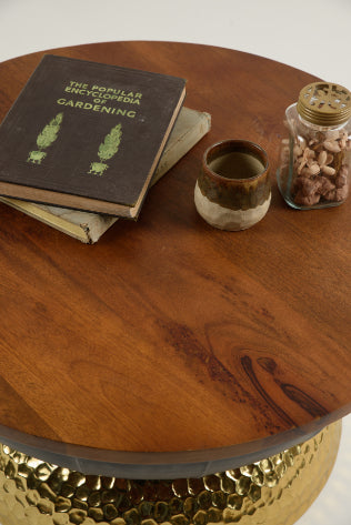 Top-down view of Valentina coffee table with warm wood finish, vintage book, and jar – modern statement piece by Troika Life.