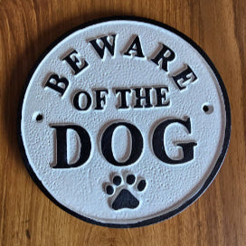 Round cast iron wall sign with embossed text 'Beware of the Dog' and paw print detail – vintage-style home safety decor by Troika.