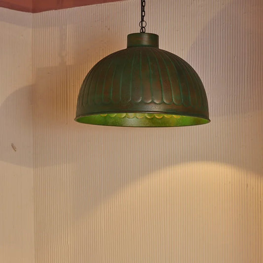 Moss green dome pendant light with vintage patina perfect for rustic and industrial-themed interiors.